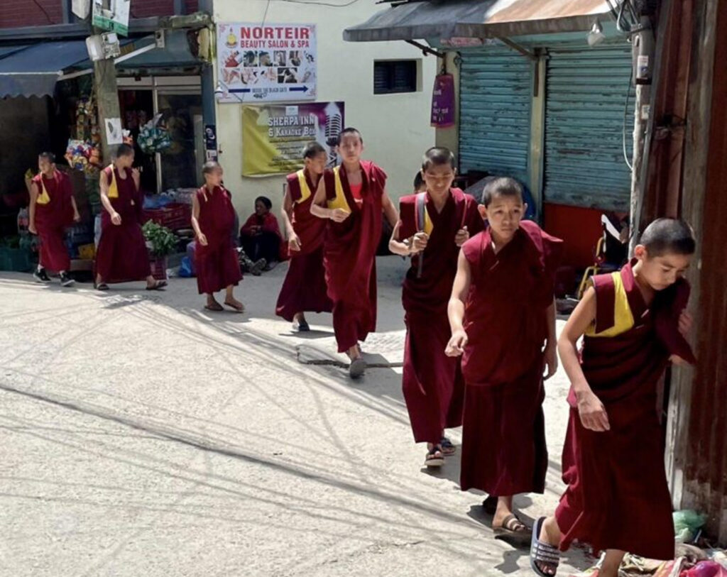 Young monks walking along a street in Kathmandu