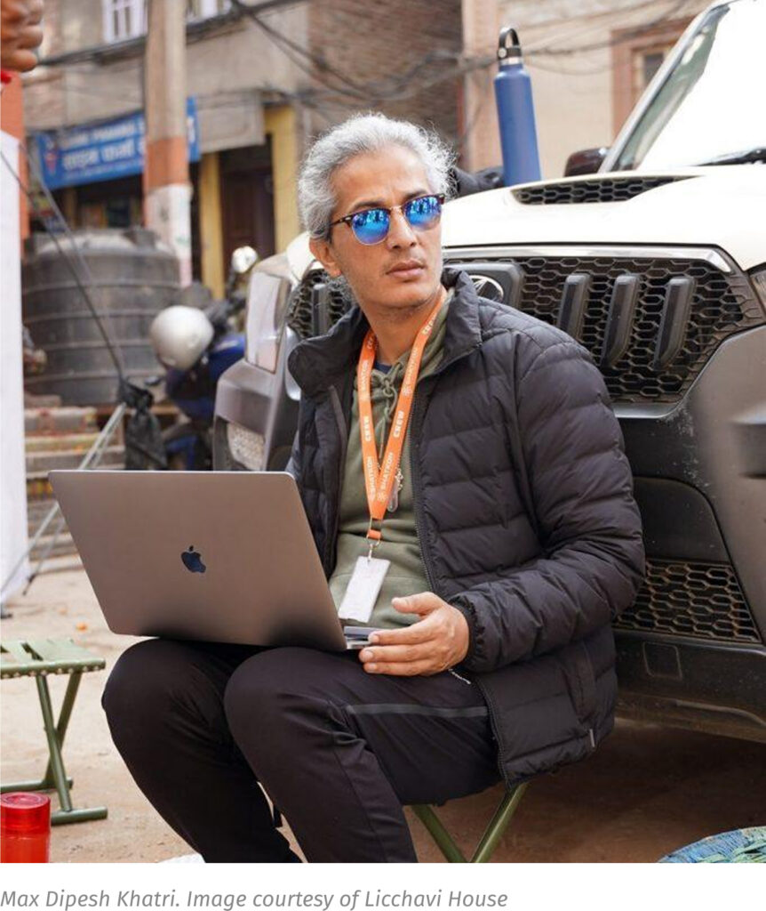 Max Dipesh Khatri with a laptop in a Kathmandu street